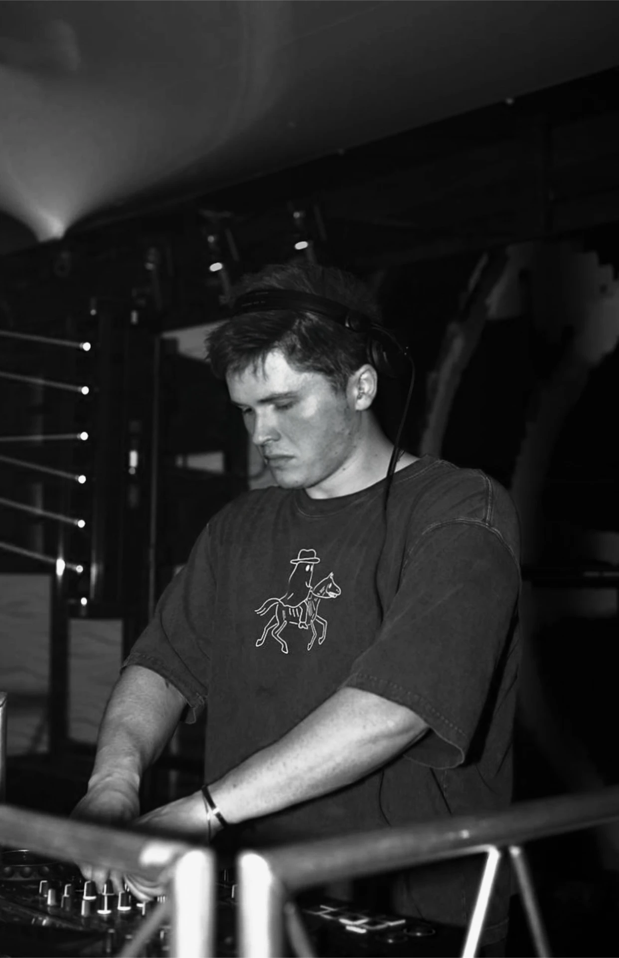Close-up of Jason Kushy focused behind the decks during a live DJ performance