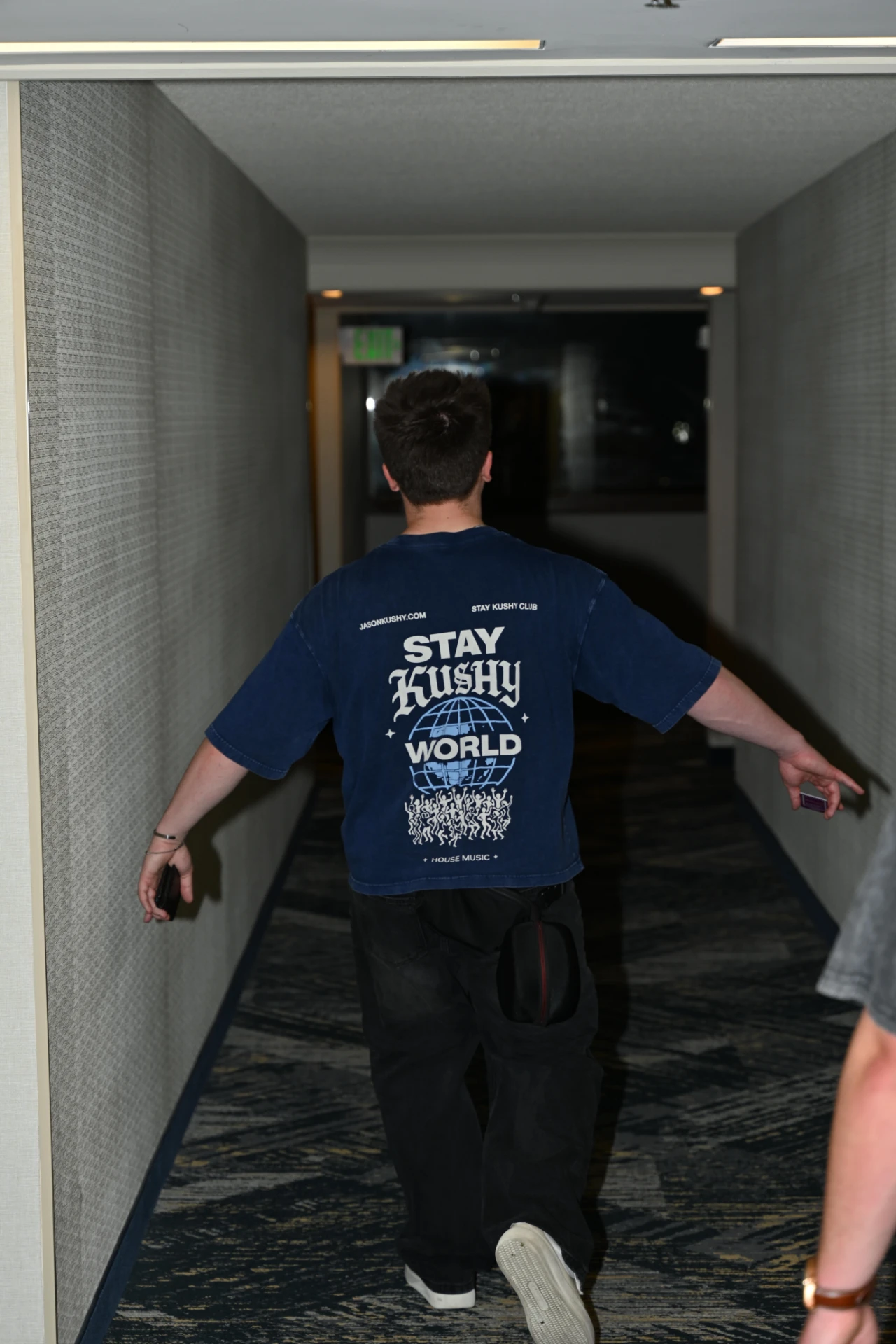 Jason Kushy in Stay Kushy streetwear, standing in a hallway