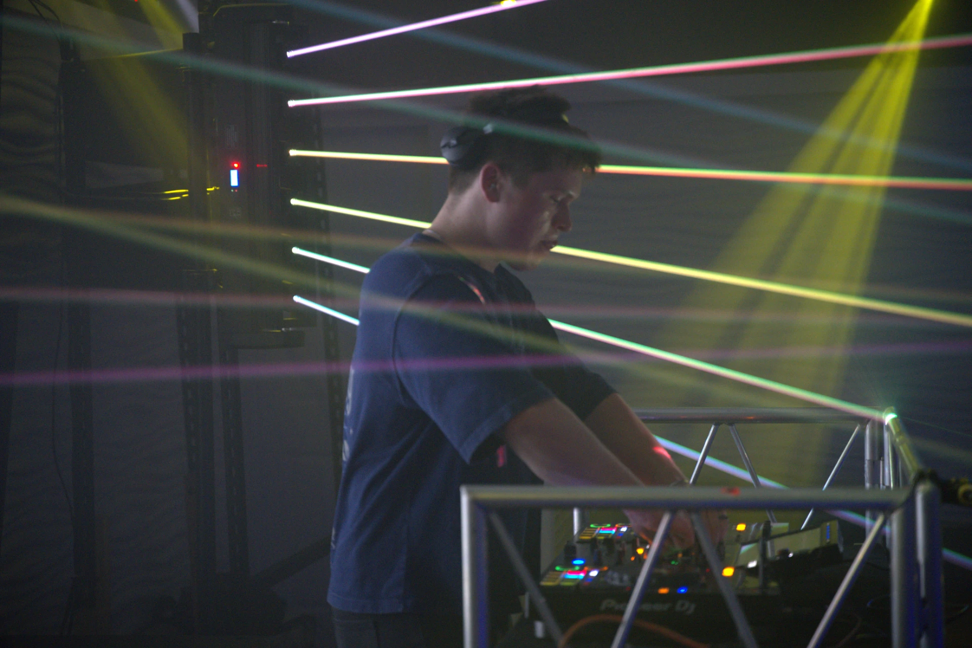 Wide shot of Jason Kushy at a mixing desk producing house music