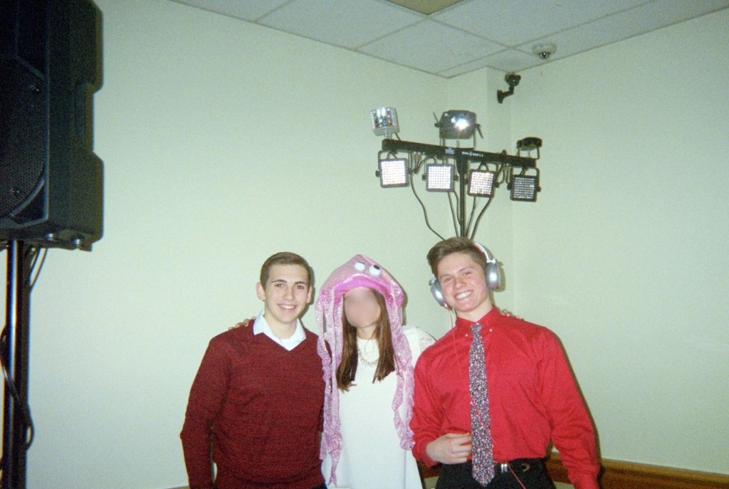Early Jason Kushy with friends, wearing headphones beside a lighting rig